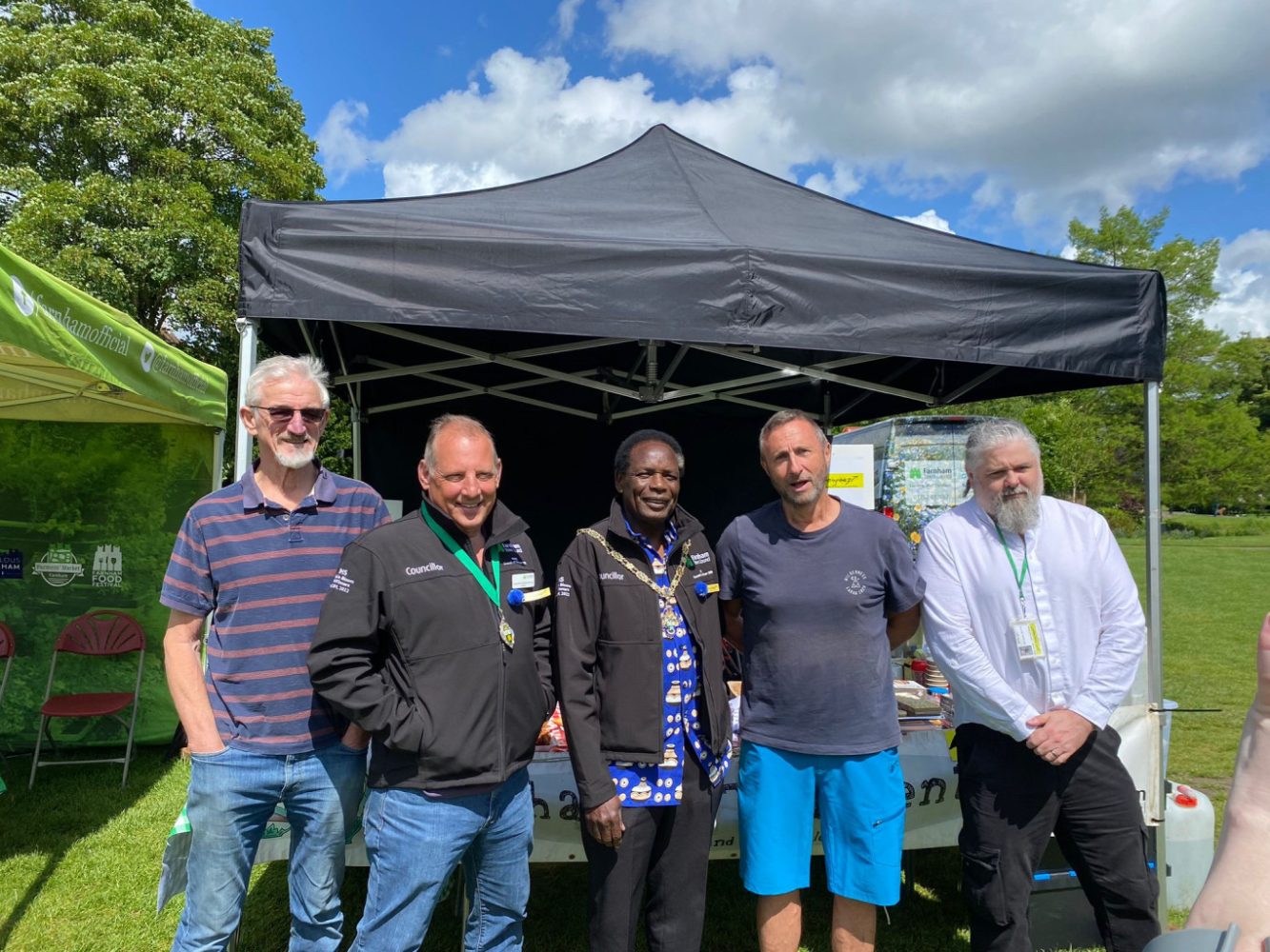 5 men standing in front of a gazebo.