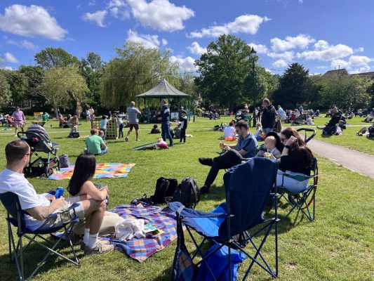 Groups of people sitting in a park