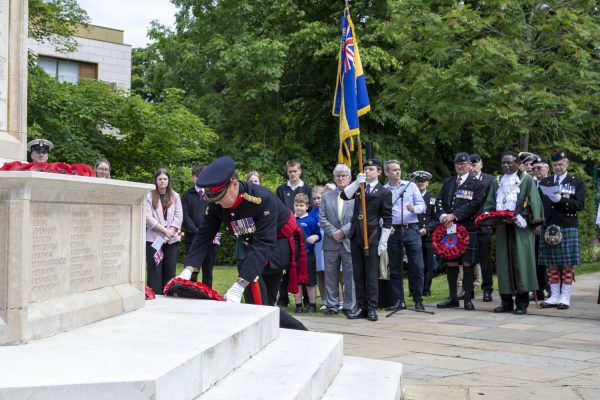 Group of people stood around a memorial