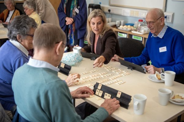 Four people playing a board game.