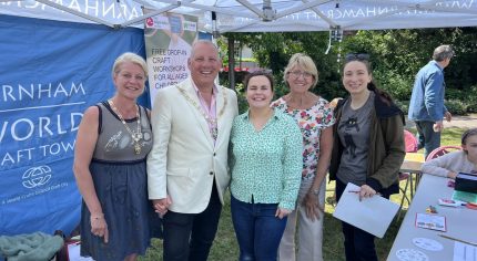 Mayor and Mayoress standing under a gazebo with three other people.