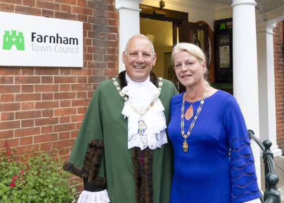 Mayor dressed in green robes and Mayoress in a blue dress.