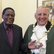 A man in a suit with the Mayor