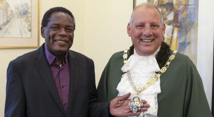 A man in a suit with the Mayor