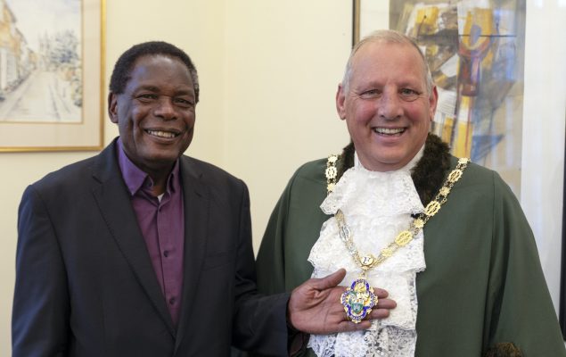 A man in a suit with the Mayor
