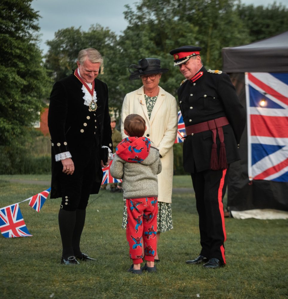 Little boy talking to three adults.
