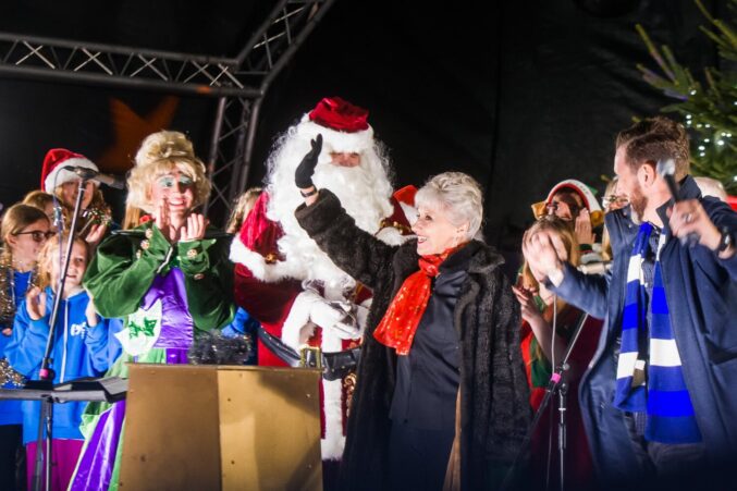 Pantomime characters, Father Christmas and a female waving