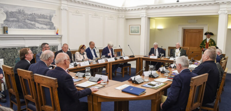People sitting around a boardroom style table.