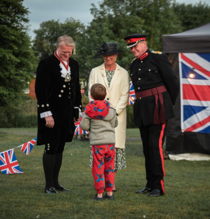Little boy talking to three adults.
