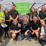 Group of people in a greenhouse celebrating Farnham in Bloom.