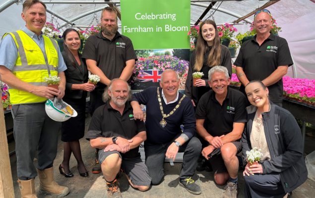 Group of people in a greenhouse celebrating Farnham in Bloom.