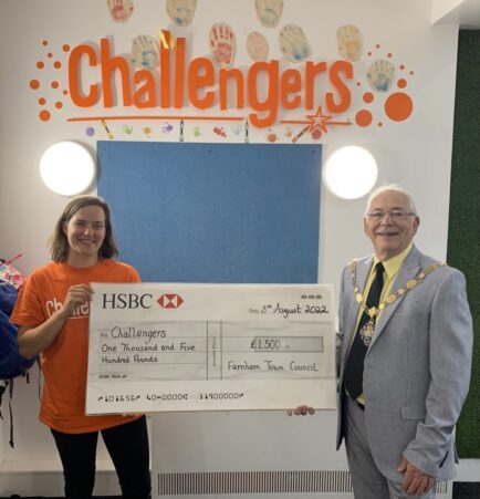 Male and female holding a large cheque