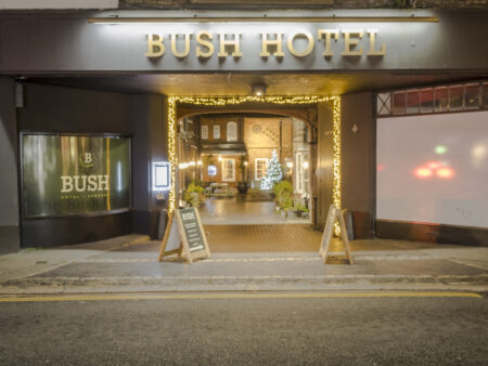 The entrance of a hotel decorated in Christmas lights