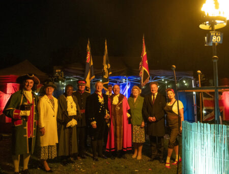 Group of people with flags in the background.