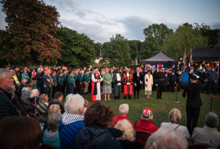 Crowd of people watching a ceremony.