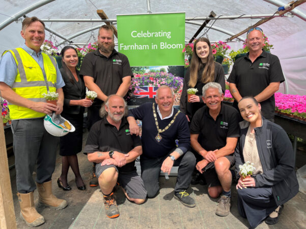 Group of people in a greenhouse celebrating Farnham in Bloom.