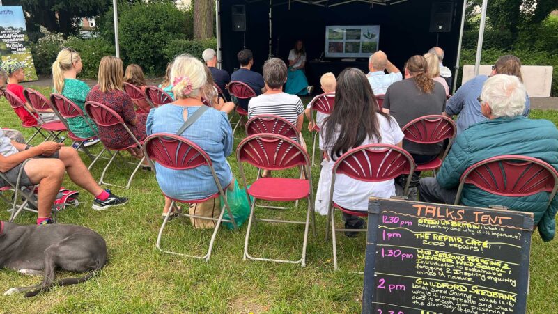 People sitting on chairs listening to a talk