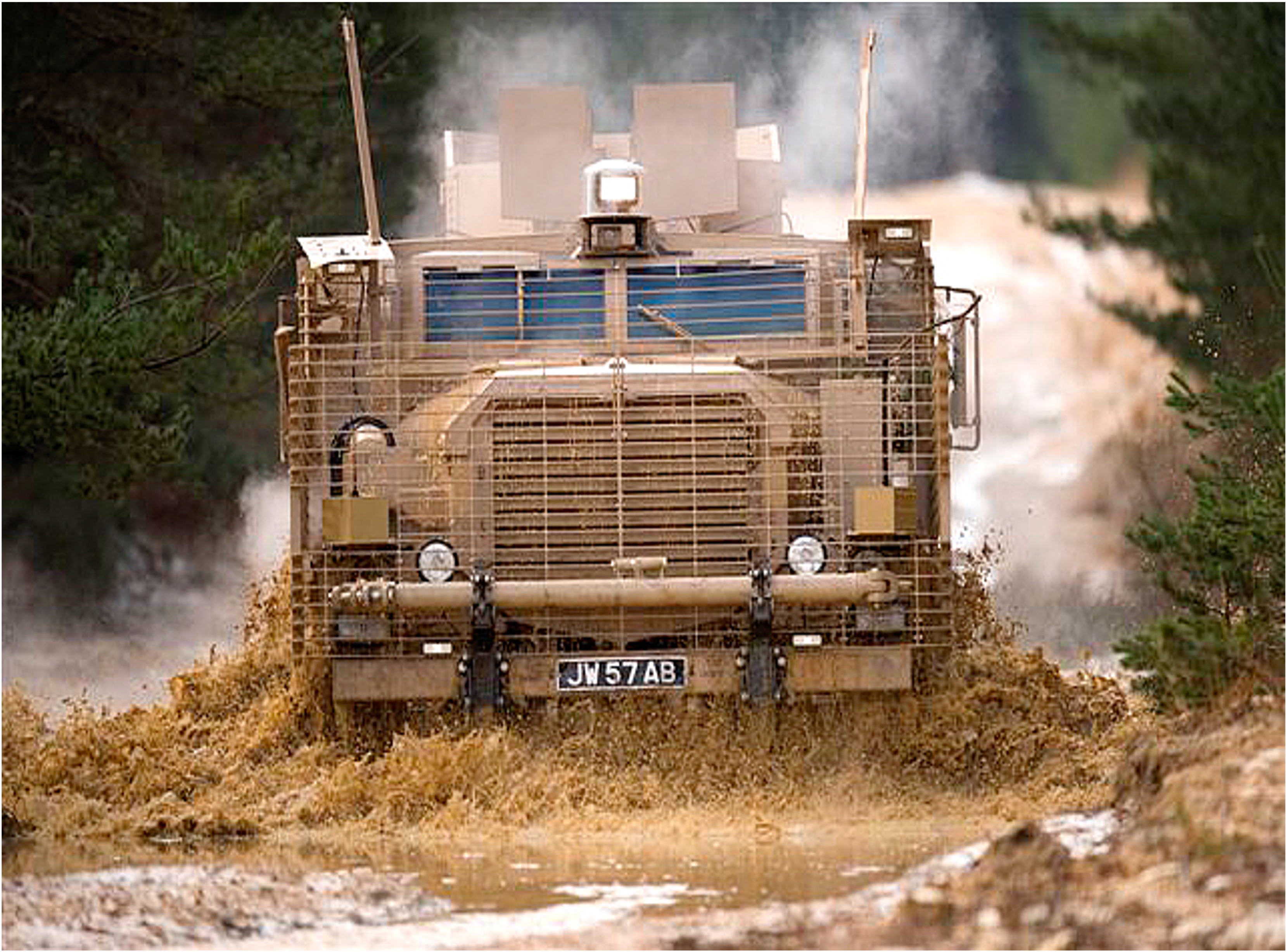 Large military vehicle driving through water.
